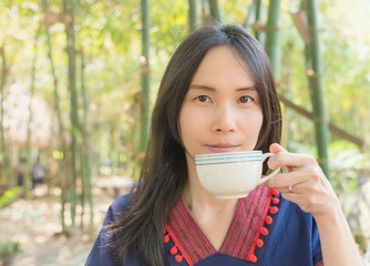 Thai lady use hand holding coffee cup