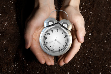 Alarm clock in palms