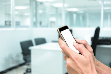 Hands using smartphone in working office