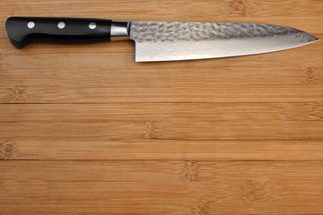 Japanese Professional Kitchen Knife On The Bamboo Cutting Board