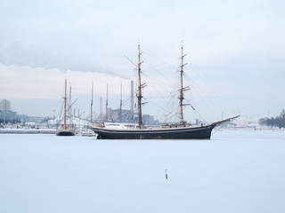 Fototapeta na wymiar The photo is took in the winter at Helsinki, Finland, Boats on the winter parking, frozen on sea ice