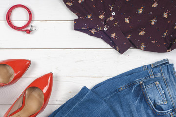 Women clothing set and accessories on a rustic wooden background.Top view,  different shoes on  light wooden background.  Copy space for text.