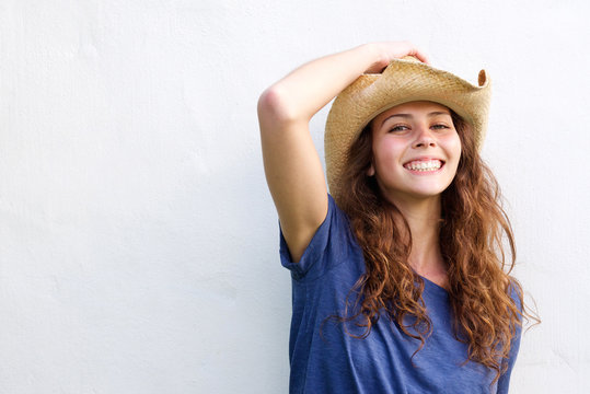 Smiling young woman with cowboy hat