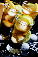 Alcoholic cocktail coconut cola, liqueur, lime, lemon and ice, b