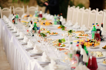 Served table in restaurant with dishes and glasses