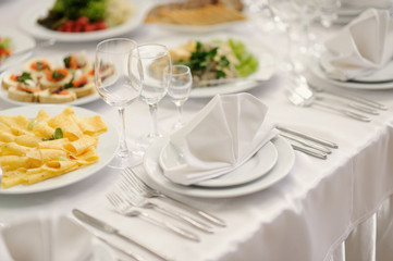 table set service with silverware and glass stemware at restaura