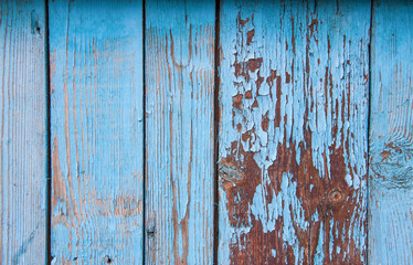 Fototapeta na wymiar old wooden fence painted in blue background