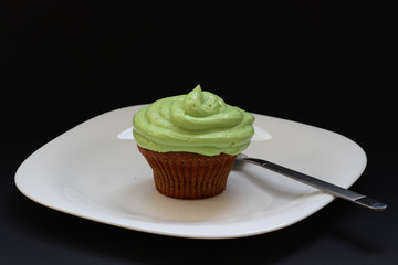 Sweet chocolate cupcake. Close up of chocolate cupcake. Muffins. Fresh delicious homemade cupcakes. Chocolate cupcakes with chocolate frosting on top with sugar sprinkles. Shallow depth of field.