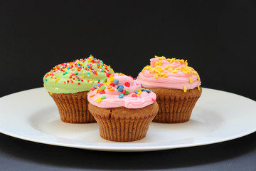 Sweet chocolate cupcake. Close up of chocolate cupcake. Muffins. Fresh delicious homemade cupcakes. Chocolate cupcakes with chocolate frosting on top with sugar sprinkles. Shallow depth of field.