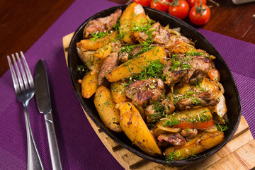 meat with potatoes in pen