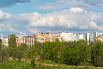 Fototapeta na wymiar Natural summer landscape with the city in the distance