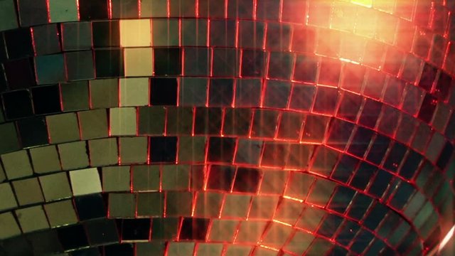 Shiny disco ball rotating in empty nightclub, glint and glittering party light decoration.