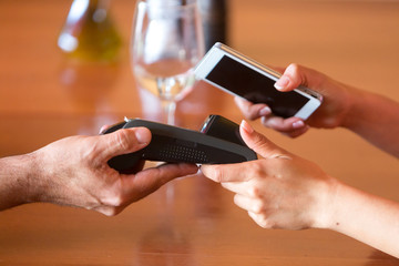 Using mobile phone at restaurant for contactless payment with NFC technology