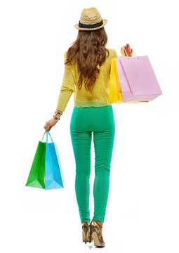 Seen From Behind Woman With Shopping Bags Making Step