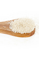 a wooden spatula with white sesame seeds