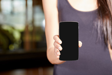 Young caucasian woman holding a mobile phone