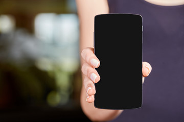 Young caucasian woman holding a mobile phone