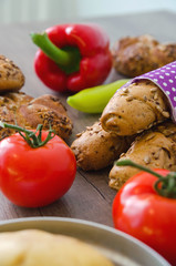 Pepper, potato, kaiser bun and baguette on wood table. Vegetarian bio food concept.