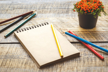 hobby painting - workplace with colored pencils, blank open notebook