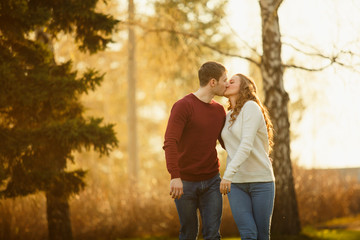 Fototapeta premium Young couple spend a weekend or holiday in park or pine forest.