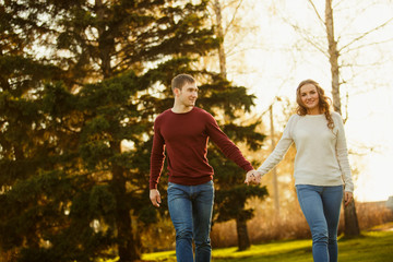 Fototapeta premium Young couple spend a weekend or holiday in park or pine forest.