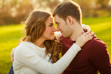 Young couple spend a weekend or holiday in park or pine forest.