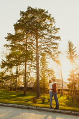 Obraz premium Young couple spend a weekend or holiday in park or pine forest.