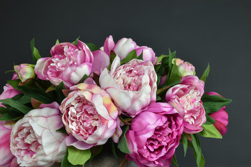 Pink bouquet peony flowers.
Dark background.