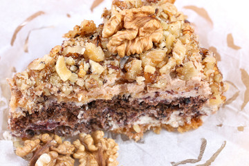 portion of white and brown chocolate walnut cake with walnuts
