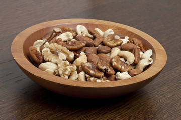 Fototapeta premium wooden bowl with assorted nuts