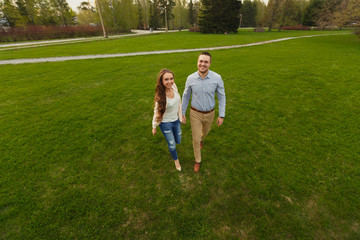Fototapeta premium Happy Smiling Couple Relaxing on Green Grass.Park