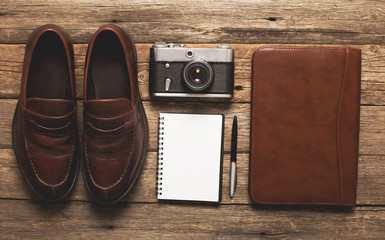 Tourism concept - set of stuff with camera and other travel things on wooden table background