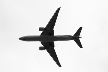 airplane flying in the blue sky with clouds