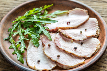 Baked meat with fresh rocket salad