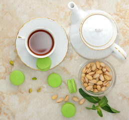 green macaron with a cup of tea