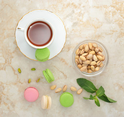 Colorful macaron with a cup of tea