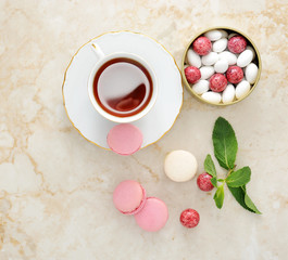 Obraz na płótnie Canvas Colorful macaron with a cup of tea