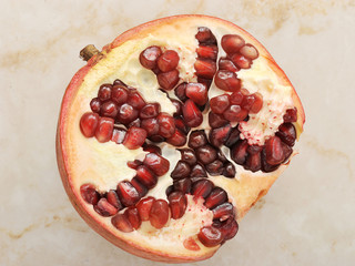 half of pomegranate on a marble background