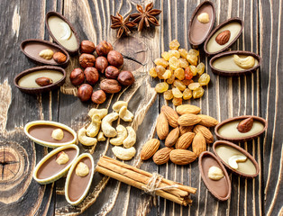 shekoladnye candy, nuts and raisins on an  wooden table