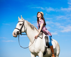 Obraz premium Woman sitting horse. Day. Half height. Pink plaid shirt