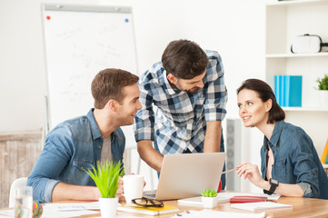 Talented three colleagues are discussing their work