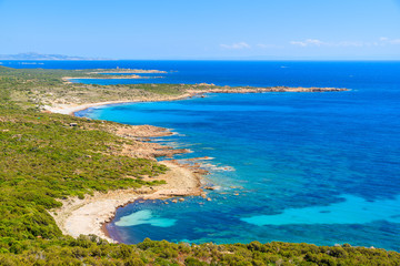 Fototapeta na wymiar A view of beautiful secluded beach and blue sea on coast of Corsica island, France