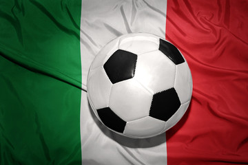 Naklejka premium black and white football ball on the national flag of italy