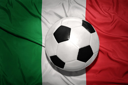 black and white football ball on the national flag of italy
