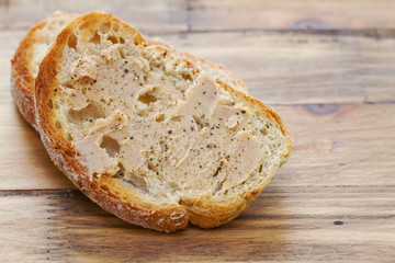 bread with sardine pate on brown wooden background