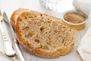 bread with fish pate on white wooden background