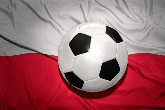 black and white football ball on the national flag of poland
