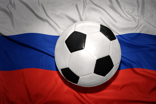 black and white football ball on the national flag of russia