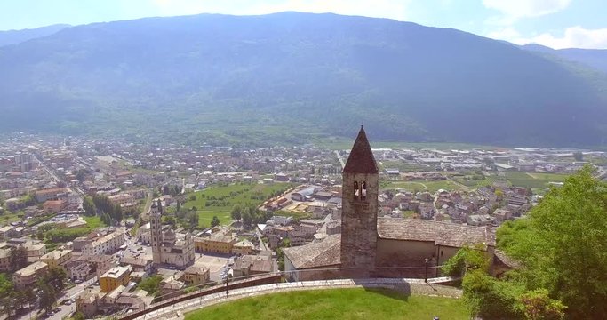 Aerial 4k - Tirano - Valtellina (IT) - Chiesetta di Santa Perpetua (Sec. VI) - Vista della Citt&agrave; e del Santuario della Beata Vergine 