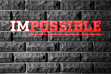 Word impossible transformed into possible on grey wall